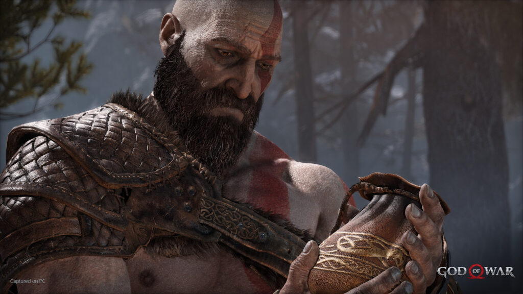 Kratos takes a moment to contemplate in God of War. 